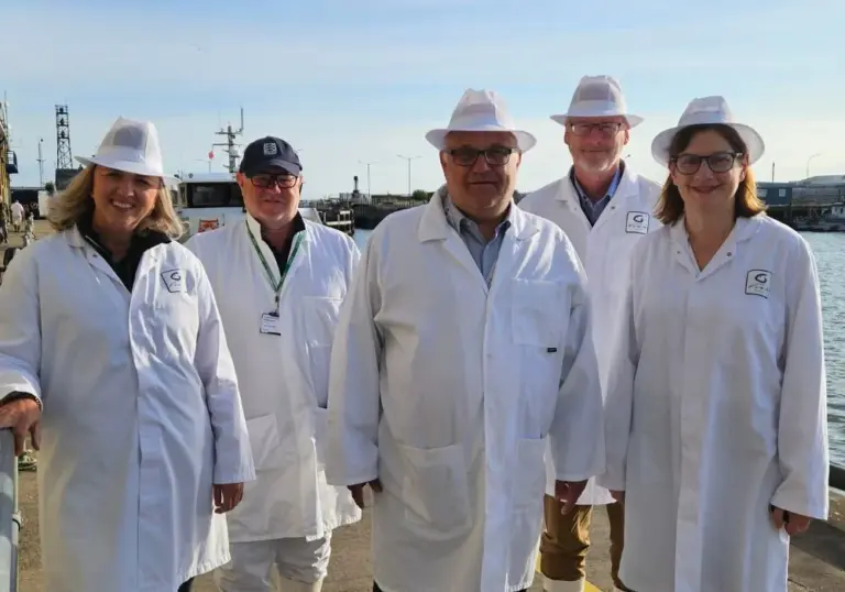 The party welcoming HM Ambassador designate to Iceland, Jane Stevens, walk along the quayside at Port of Grimsby East, alongside Grimsby Fish Market.